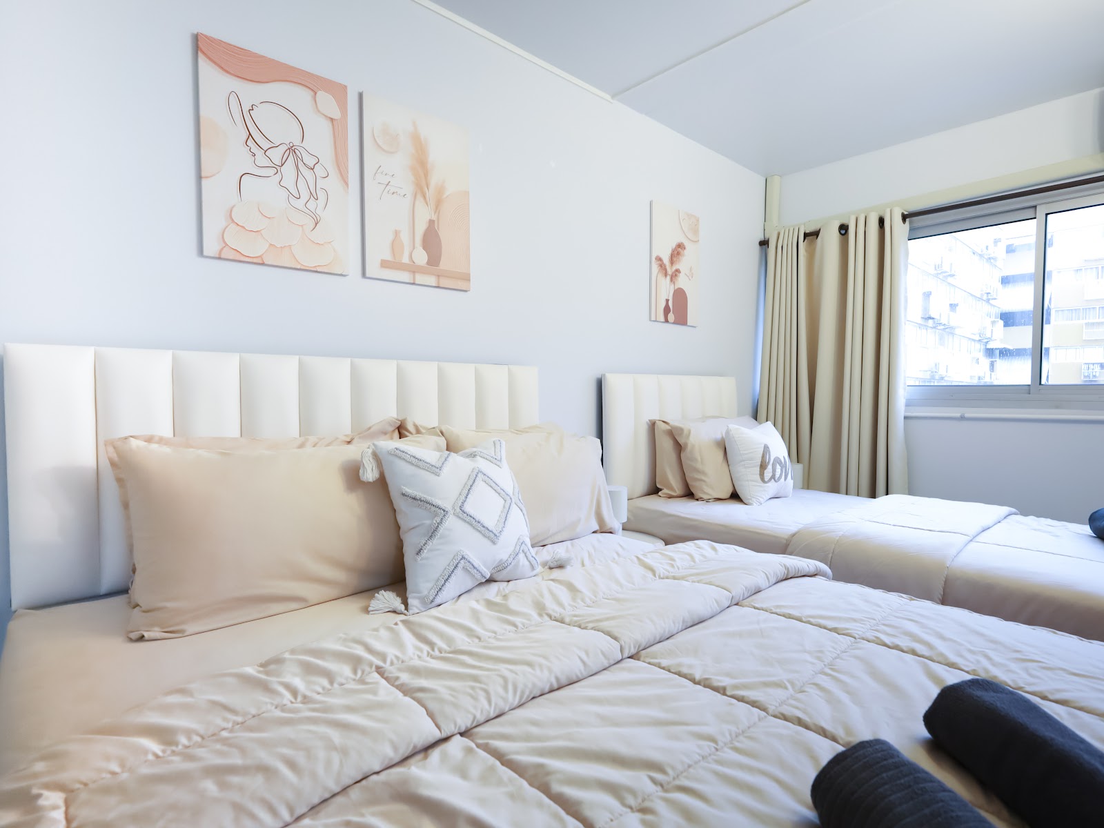Twin beds with blush wall art
